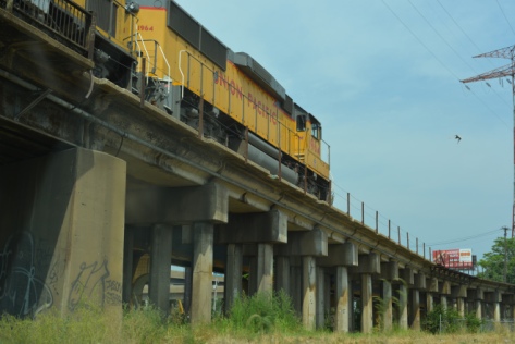 yellow train on a bridge 
